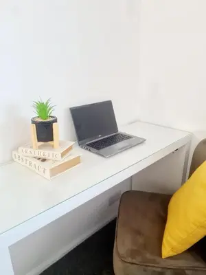 a white desk with a laptop on top of it at Chelmsford Getaway Business and Leisure