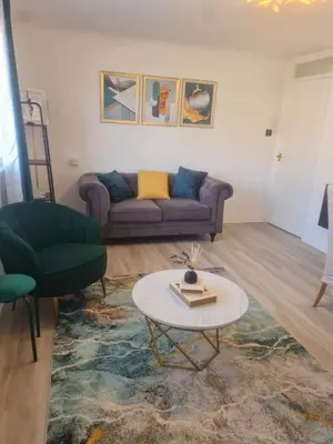 a living room with a couch and a table at Chelmsford Getaway Business and Leisure