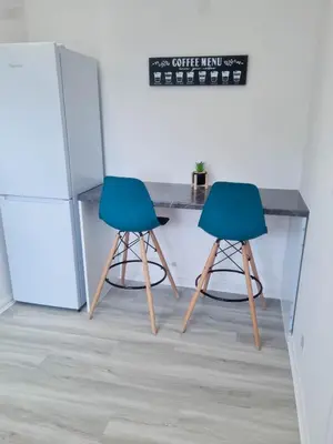 two chairs sitting at a table in a kitchen at Chelmsford Getaway Business and Leisure