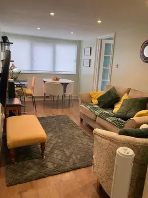 a living room with a couch and a table at The Cosy Annexe in Wymondham