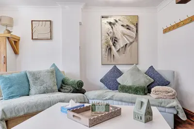 a living room with two couches and a table at Quirky 2-Bed Brentwood Home Near High St & Station - With Parking in Brentwood