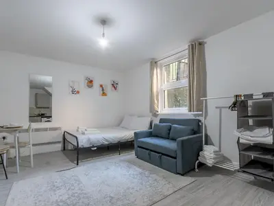 a living room with a couch and a bed at Cosy flat in the heart of Southend Pass The Keys in Southend-on-Sea