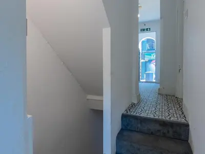 a staircase in a building with a stair case at Cosy flat in the heart of Southend Pass The Keys in Southend-on-Sea
