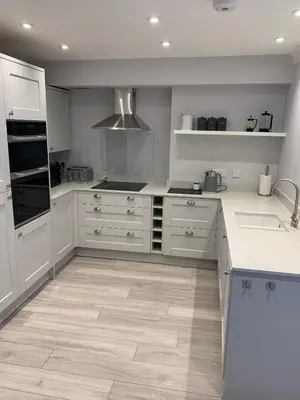 a kitchen with white counters and white cabinets at The Annexe Westbury House in Great Dunmow