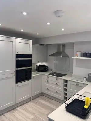 a kitchen with white cabinets and a stove at The Annexe Westbury House in Great Dunmow