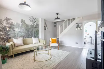 a living room with a couch and a glass table at Stylish 2-Bed Home in Cambridge in Cambridge