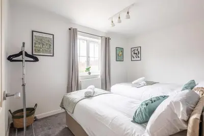 a bedroom with two beds and a window at Stylish 2-Bed Home in Cambridge in Cambridge
