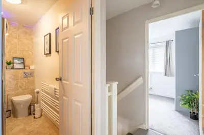 a bathroom with a white door and a toilet at Stylish 2-Bed Home in Cambridge in Cambridge