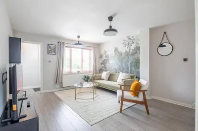 a living room with a couch and a table at Stylish 2-Bed Home in Cambridge in Cambridge