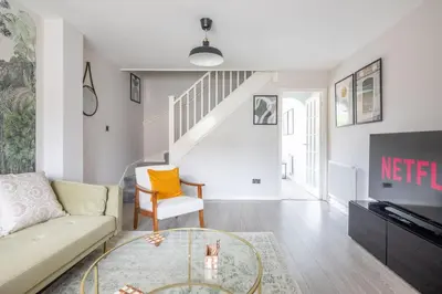a living room with a couch and a table at Stylish 2-Bed Home in Cambridge in Cambridge
