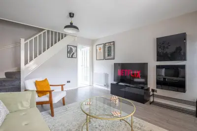 a living room with a couch and a tv at Stylish 2-Bed Home in Cambridge in Cambridge