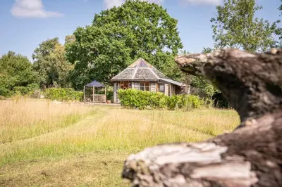 a small house in the middle of a field at Farm View Cabin, Kelsale in Kelsale