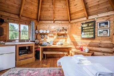 a kitchen with a table in a wooden cabin at Farm View Cabin, Kelsale in Kelsale