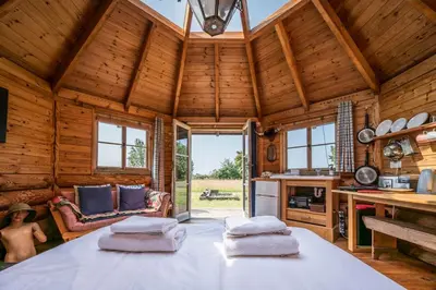 a room with a large table in a log cabin at Farm View Cabin, Kelsale in Kelsale