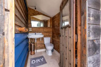 a bathroom with a toilet and a sink at Farm View Cabin, Kelsale in Kelsale