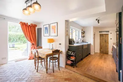 a kitchen with a table and a dining room at Farm View suite, Kelsale in Kelsale