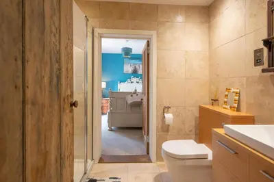 a bathroom with a toilet and a sink at Farm View, ground floor bedroom in Kelsale