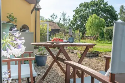 a wooden table with a plate of fruit on it at Farm View, ground floor bedroom in Kelsale