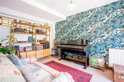 a living room with a piano against a wall at Farm View, ground floor bedroom in Kelsale
