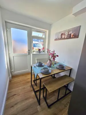 a dining room with a table and a window at Hertfordshire - Stylish 6BR Retreat, 3 Parking in Stevenage