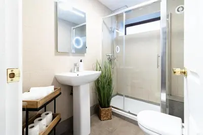 a bathroom with a sink and a shower at Large 6-BDR House in Cambridge in Barnwell Junction Station