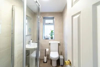a bathroom with a toilet and a sink at Large 6-BDR House in Cambridge in Barnwell Junction Station