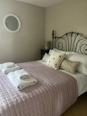 a bedroom with two white towels on a bed at Cottage nestled in the heart of a stunning Suffolk Village in Chediston
