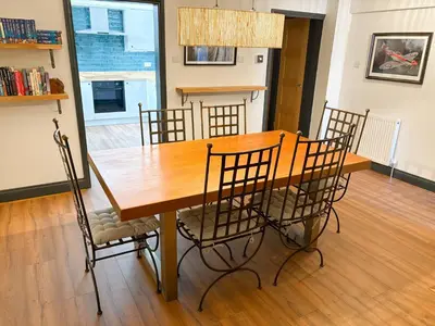 a wooden dining room table with chairs around it at 4 Bed Home In Central Maldon in Maldon