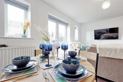 a dining room with a table with blue dishes on it at Modern 3-Bed 3-Bath Home - Quiet Road - Parking For 2 Cars - LMV Property in Great Burstead