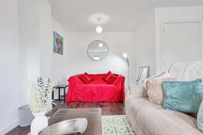 a living room with a red couch in the corner at Modern 3-Bed 3-Bath Home - Quiet Road - Parking For 2 Cars - LMV Property in Great Burstead