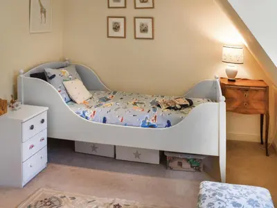 a childs bedroom with a bed and a dresser at Green Farm Cottage in Redgrave