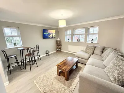 a living room with a couch and a table at Apartment I Sleeps 4 I Wi-Fi I Parking I Rail Links I Newmarket in Newmarket