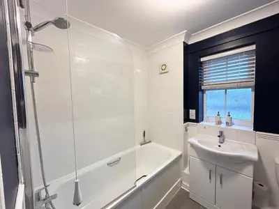 a bathroom with a tub and a sink and a shower at Apartment I Sleeps 4 I Wi-Fi I Parking I Rail Links I Newmarket in Newmarket