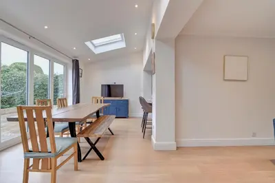 a dining room with a table and chairs at Spacious 4 bedroom house in Bishop's Stortford in Thorley