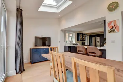 a kitchen and dining room with a table and chairs at Spacious 4 bedroom house in Bishop's Stortford in Thorley