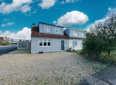 a white house with a red roof at The Larks Spacious 3BR Essex in Vange