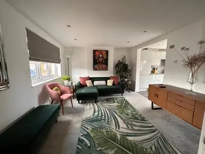 a living room with a couch and a table at The Larks Spacious 3BR Essex in Vange