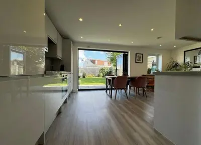 a kitchen and dining room with a table and chairs at The Larks Spacious 3BR Essex in Vange