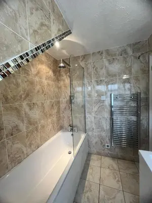 a bathroom with a shower and a bath tub at Rivenhall Garden Hotel in Rivenhall