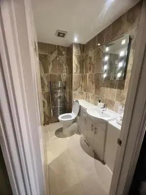 a bathroom with a toilet and a sink at Rivenhall Garden Hotel in Rivenhall