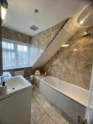 a bathroom with a sink and a tub and a staircase at Rivenhall Garden Hotel in Rivenhall