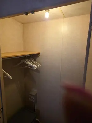 a closet with a shelf and a light in it at St Osyth, Clacton-on-sea, Cozy Beach side Caravan, Wifi, Tea and Coffee, Parking included in Saint Osyth