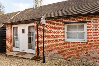 a brick house with a white door and a window at Cosy Barn Conversion - peaceful, private double room in Shenfield