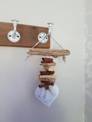 a shelf made out of wood with a bike on it at Cosy Barn Conversion - peaceful, private double room in Shenfield