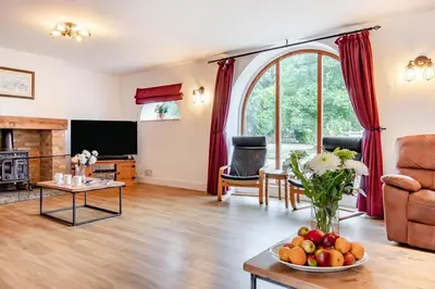 a living room with a television and a table with fruit at 6 Bed in Three Holes oc-t31855 in Upwell