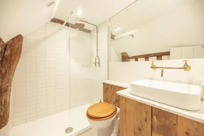 a bathroom with a toilet and a sink and a shower at Charming 2BR Cottage in Orford