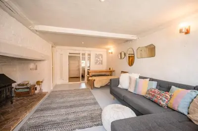 a living room with a couch and a fireplace at Charming 2BR Cottage in Orford