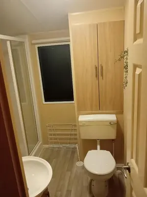 a small bathroom with a toilet and a sink at Comfortable and Spacious Mobile home - Sleeps 6, in Clacton-on-Sea