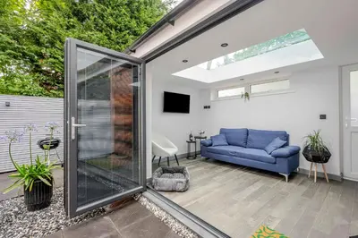 a living room with a sliding glass door at Detached House in Quiet Village - Pets Allowed in Ipswich