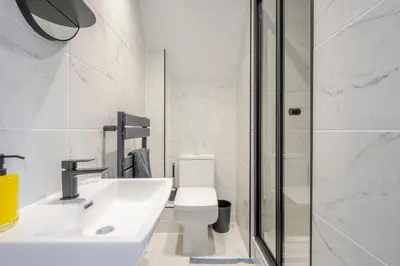 a bathroom with a toilet and a sink and a shower at Detached House in Quiet Village - Pets Allowed in Ipswich